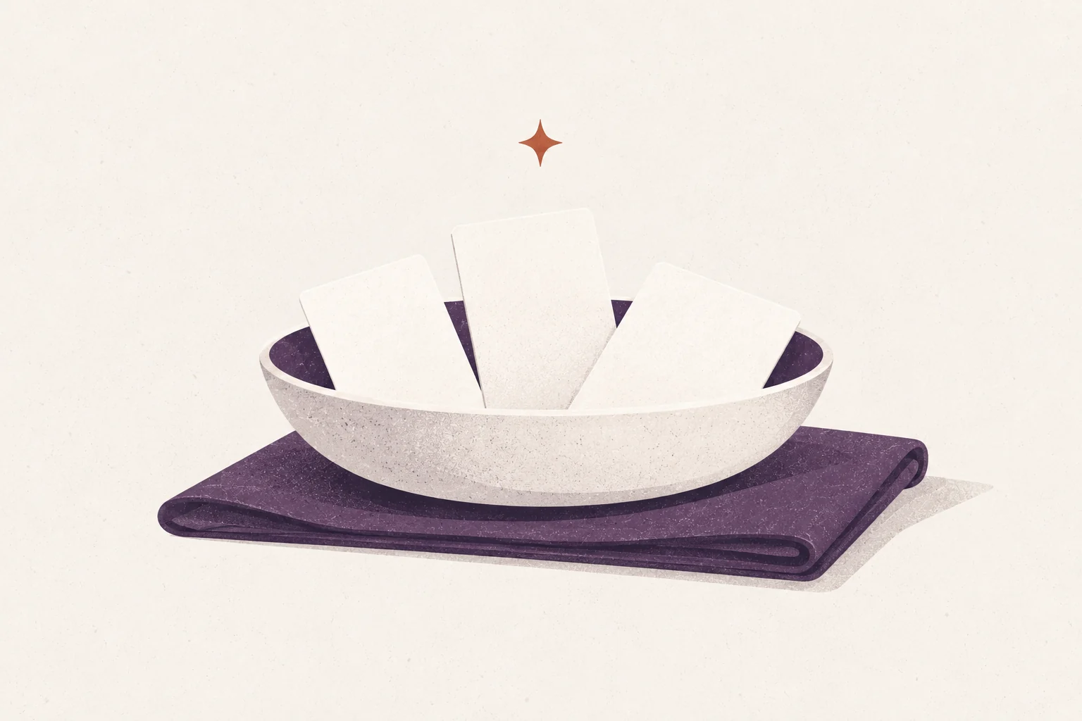 A shallow bowl holding three blank support cards on a folded cloth with a small ember spark.